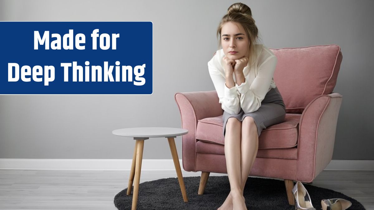 People and lifestyle concept. Beautiful young female teacher with hair bun relaxing at home after lectures at college, sitting barefooted in armchair.