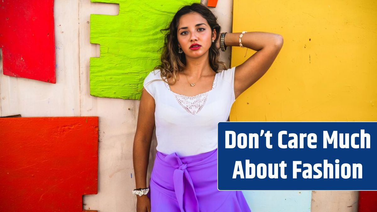 Stylish female wearing a purple skirt paired with a white shirt and posing against an old building.