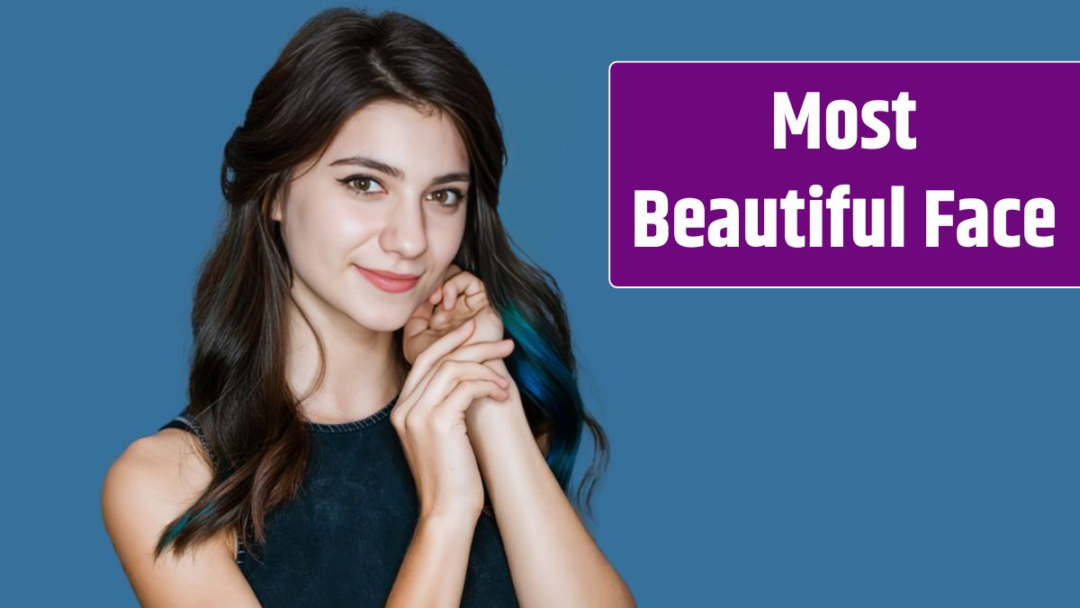 Close up shot of stylish young brunette woman with blue strands of hair smiling against blue background.