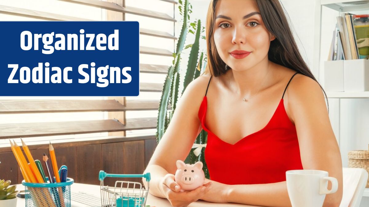 Successful young woman holding a pink piggy bank in her hands while sitting in office.