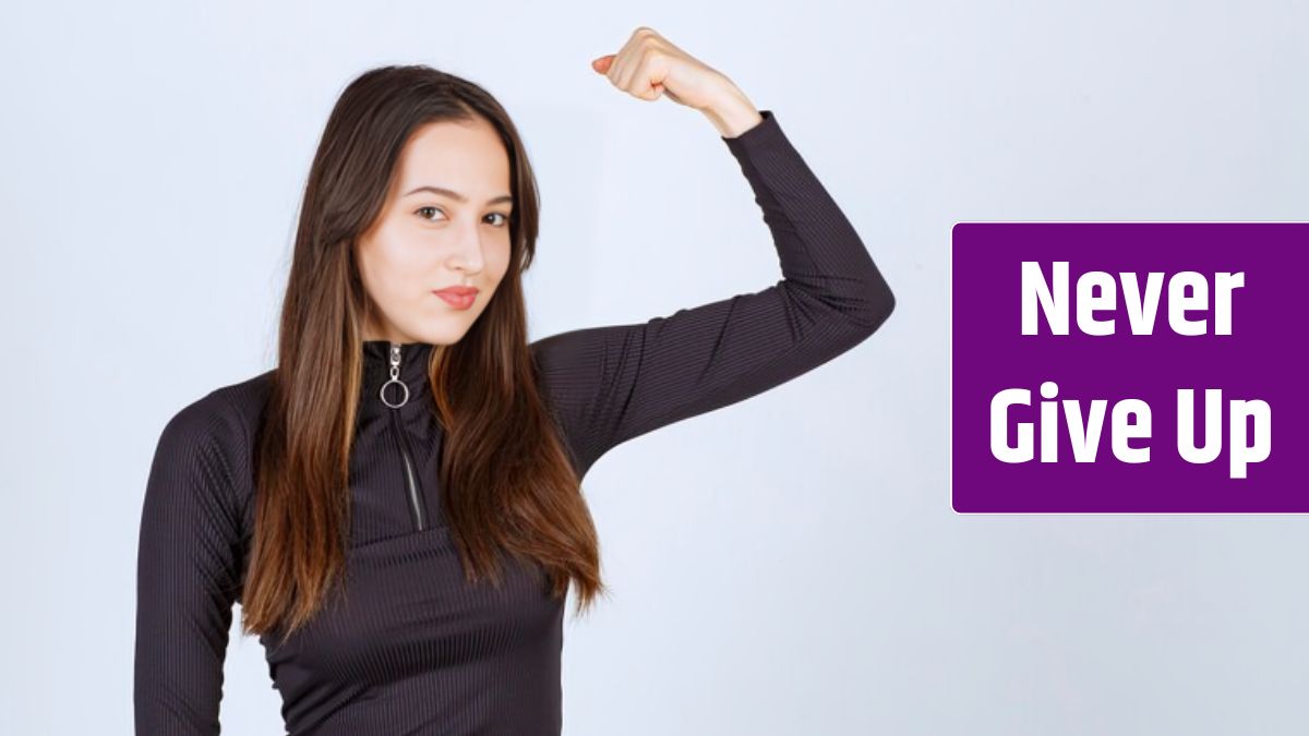 Girl in black clothes showing her fist and arm muscles.